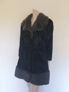 Fabulous little faux fur mini coat, just the thing that Twiggy might have worn. Black synthetic fur coat has a large fluffy grey collar and hem band. It has two side seam pockets and a matching tie running through carriers at the waist. Bound buttonholes. I have added three vintage metal buttons as the originals were missing. Fully lined with rayon or acetate. No labels at all - 1960s. Small.