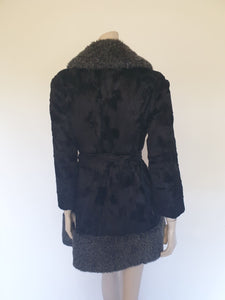 Fabulous little faux fur mini coat, just the thing that Twiggy might have worn. Black synthetic fur coat has a large fluffy grey collar and hem band. It has two side seam pockets and a matching tie running through carriers at the waist. Bound buttonholes. I have added three vintage metal buttons as the originals were missing. Fully lined with rayon or acetate. No labels at all - 1960s. Small.