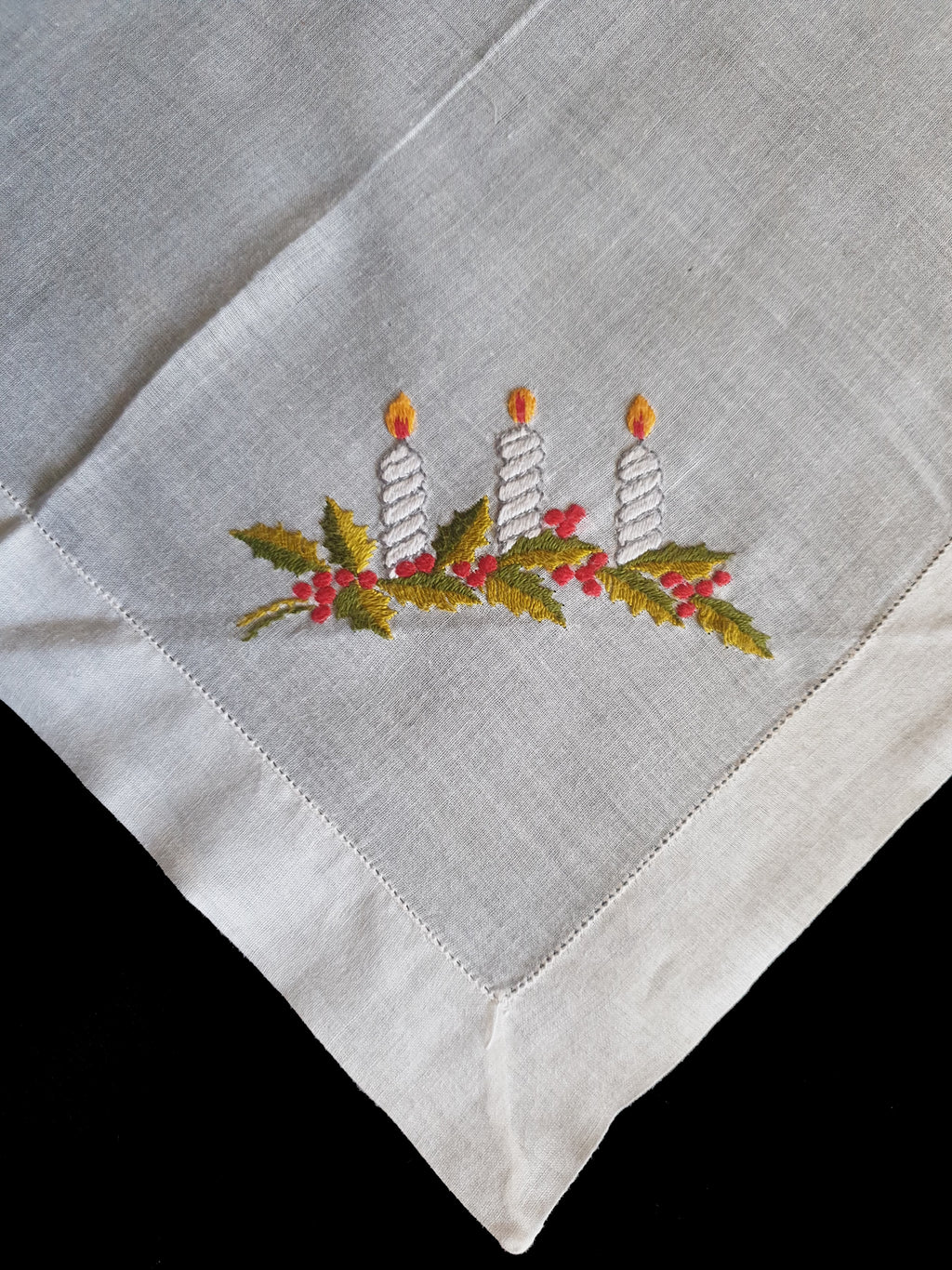 Beautiful hand embroidered Christmas handkerchief, probably made as a Christmas present at least 70 years ago. Three candles and holly leaves beautifully worked on this very fine cotton batiste hanky. If you look at the reverse side in the last photo, it's almost as neat as the front, a sign of superior needlework. The edges have been hem stitched and spoke stitched. 1950s or older.