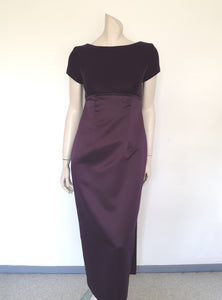 Beautiful and elegant aubergine formal sheath style gown with velvet bodice and stunning rear view. The gown has a wide neckline cut low at the back where it features a diamante studded bow extending into a narrow train over the the rear of the dress. Beneath the train the gown is slit to above the knee. The bodice is velvet and the satin skirt falls from beneath the bust. Closes at the back with a zip and a fancy button. Fabric is polyester. Made in Australia. Brand is Aurelie - 1980s. XS
