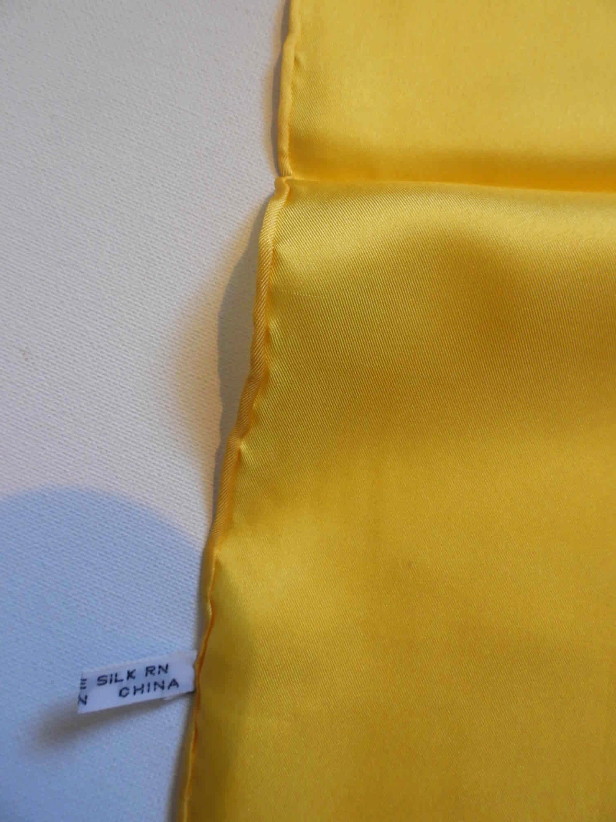 Yellow silk pocket square has hand rolled edges. Tag says 100% pure silk - Made in China.