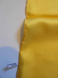 Yellow silk pocket square has hand rolled edges. Tag says 100% pure silk - Made in China.