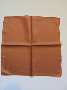 Brown silk pocket square has machined edges. No label.