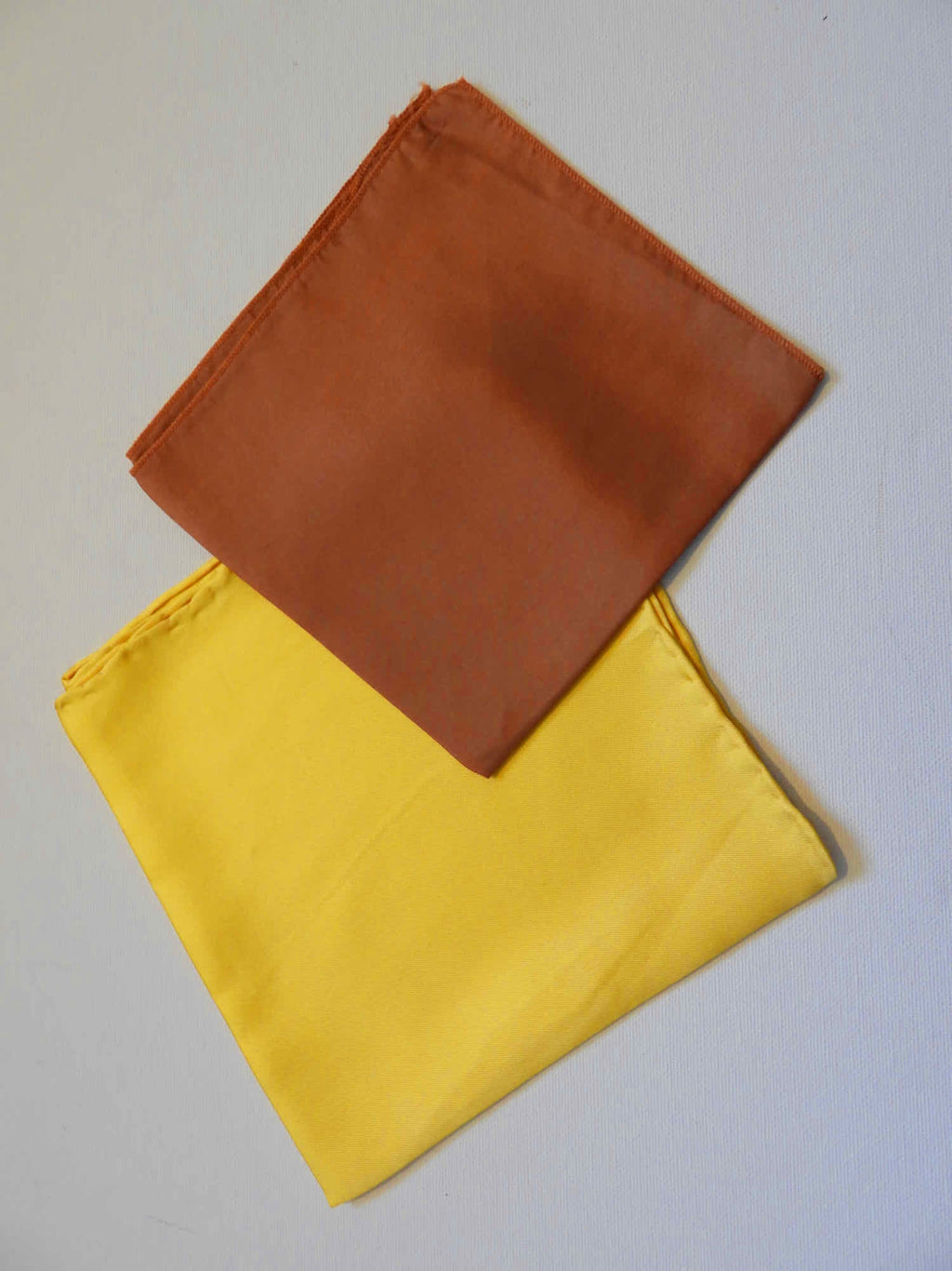Silk pocket squares for men or women - add a bit of dash to the breast pocket of your jacket. Try two colours together for an extra pop.

Available in yellow or brown.