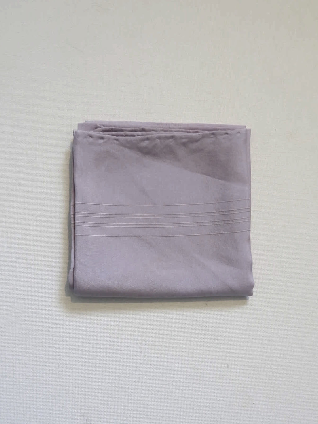 Large lavender coloured pocket handkerchief for adding just a touch of colour to your suit. The hanky has woven borders and hand rolled edges. The colour is very pale, not like the close ups. Pure silk. Made in England and marked Macclesfield Silk with an embroidered label.