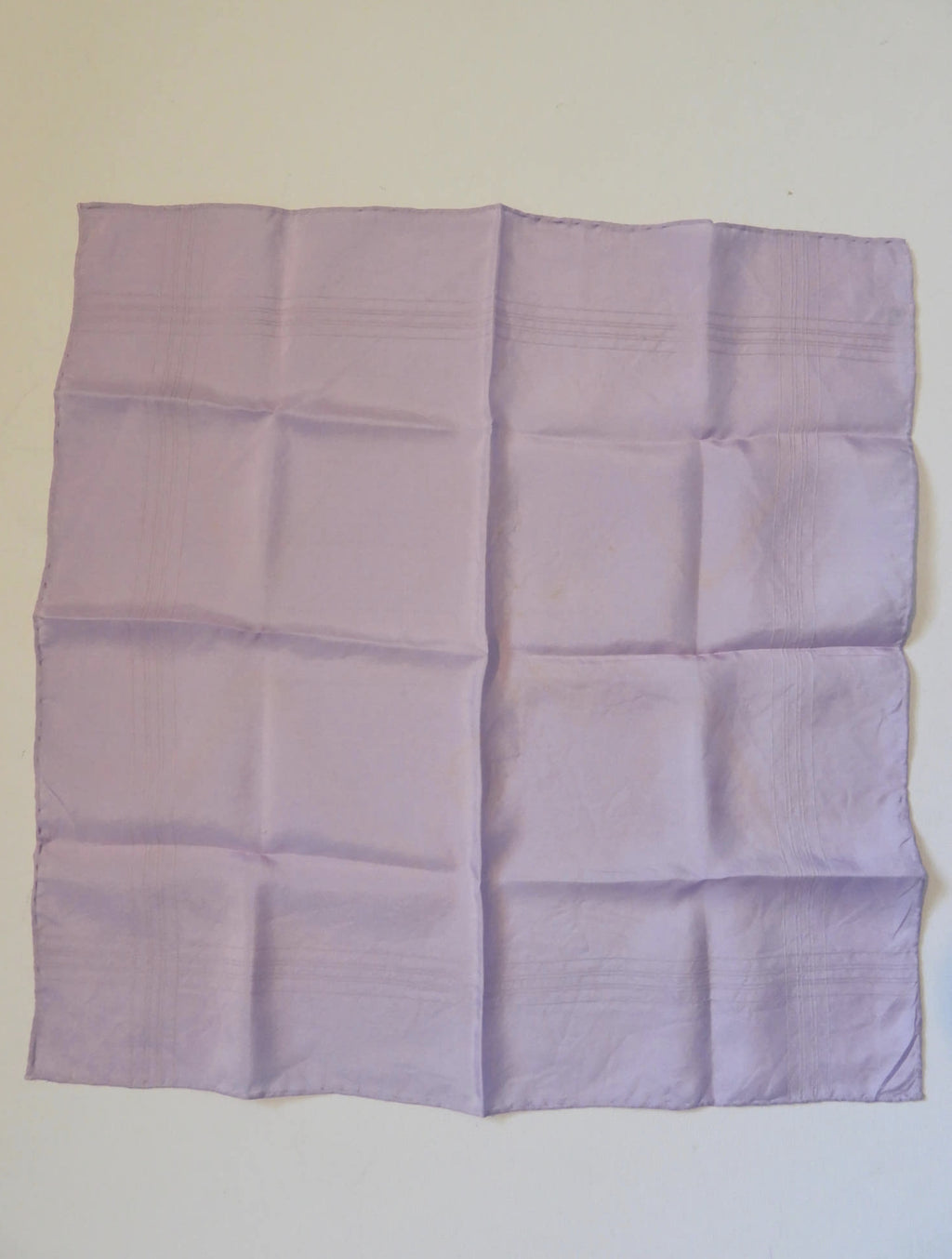Large lavender coloured pocket handkerchief for adding just a touch of colour to your suit. The hanky has woven borders and hand rolled edges. The colour is very pale, not like the close ups. Pure silk. Made in England and marked Macclesfield Silk with an embroidered label.