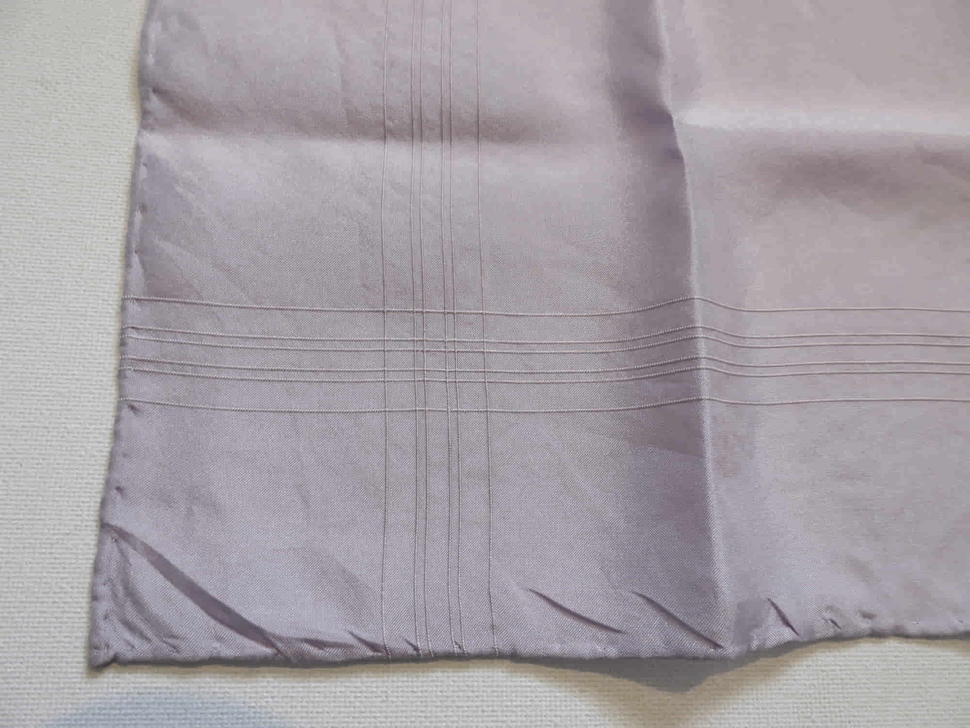 Large lavender coloured pocket handkerchief for adding just a touch of colour to your suit. The hanky has woven borders and hand rolled edges. The colour is very pale, not like the close ups. Pure silk. Made in England and marked Macclesfield Silk with an embroidered label.