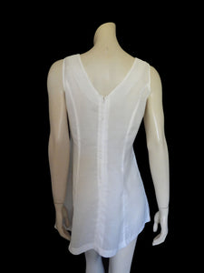 Tennis dress is decorated at centre front with eyelet embroidery. It has princess seaming and closes at the back with a zipper. The dress is semi sheer. The fabric appears to be an early form of polyester or maybe nylon, there's no fabric tag. The label reads "A Belle Garment Exclusive Model" - early 1960s. Medium