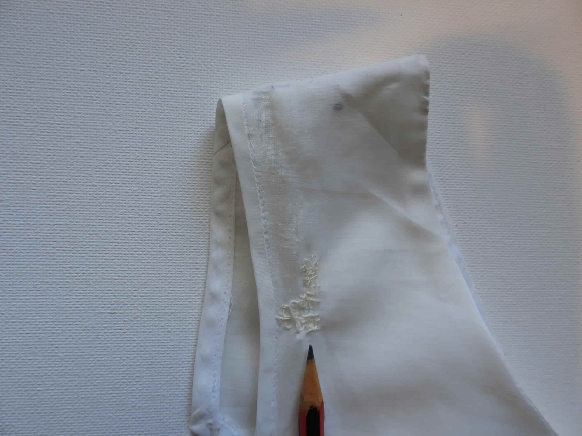 Tennis dress is decorated at centre front with eyelet embroidery. It has princess seaming and closes at the back with a zipper. The dress is semi sheer. The fabric appears to be an early form of polyester or maybe nylon, there's no fabric tag. The label reads "A Belle Garment Exclusive Model" - early 1960s. Medium
