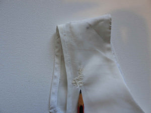 Tennis dress is decorated at centre front with eyelet embroidery. It has princess seaming and closes at the back with a zipper. The dress is semi sheer. The fabric appears to be an early form of polyester or maybe nylon, there's no fabric tag. The label reads "A Belle Garment Exclusive Model" - early 1960s. Medium
