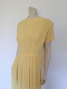 1960s vintage yellow crepe dress with box pleated skirt