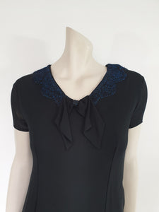 1960s vintage black mini dress with blue glitter neckline