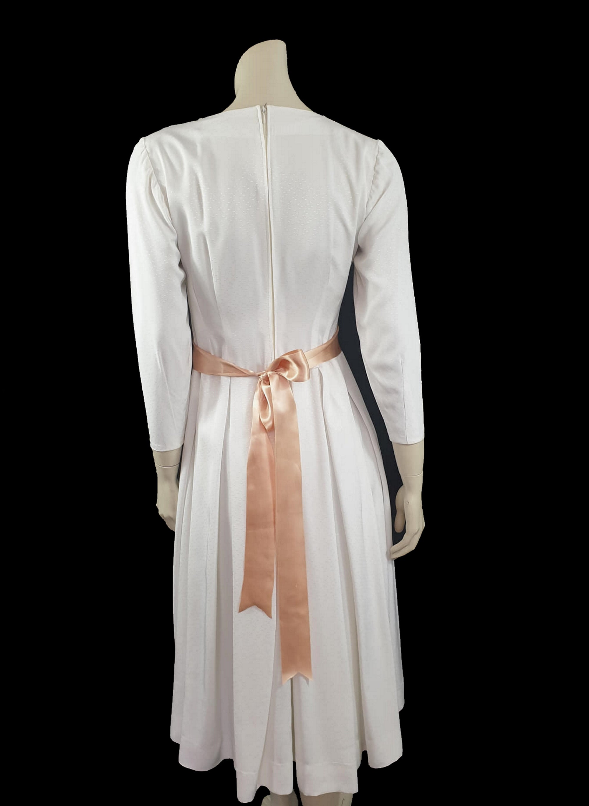 1960s white long sleeved dress with pleated skirt